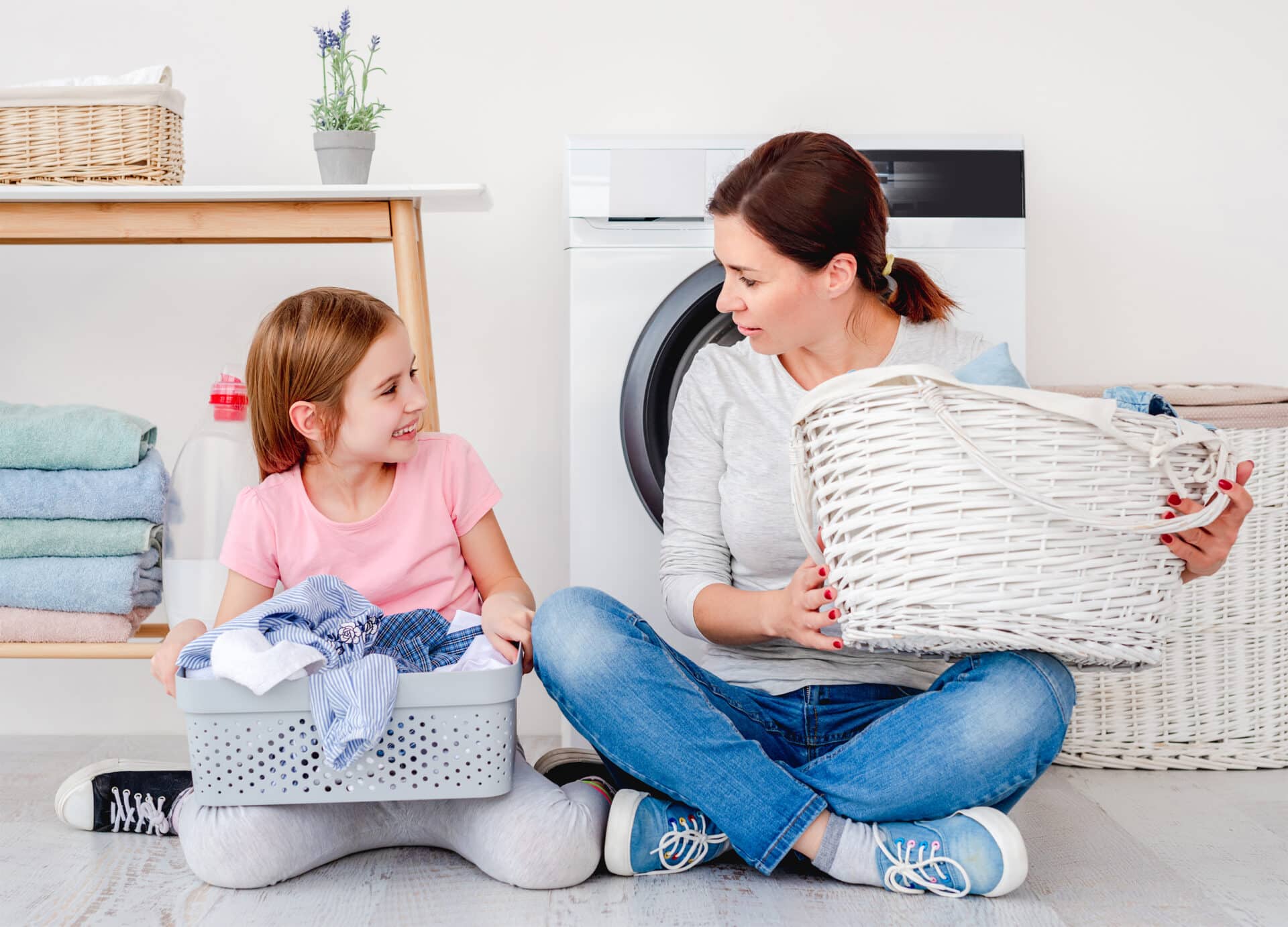 Little girl helping mother during washing
